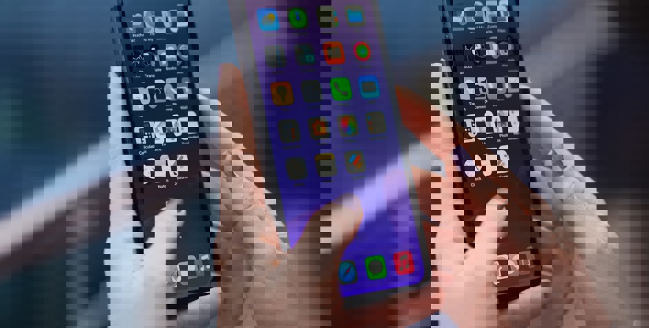 Woman with purple nails using iPhone